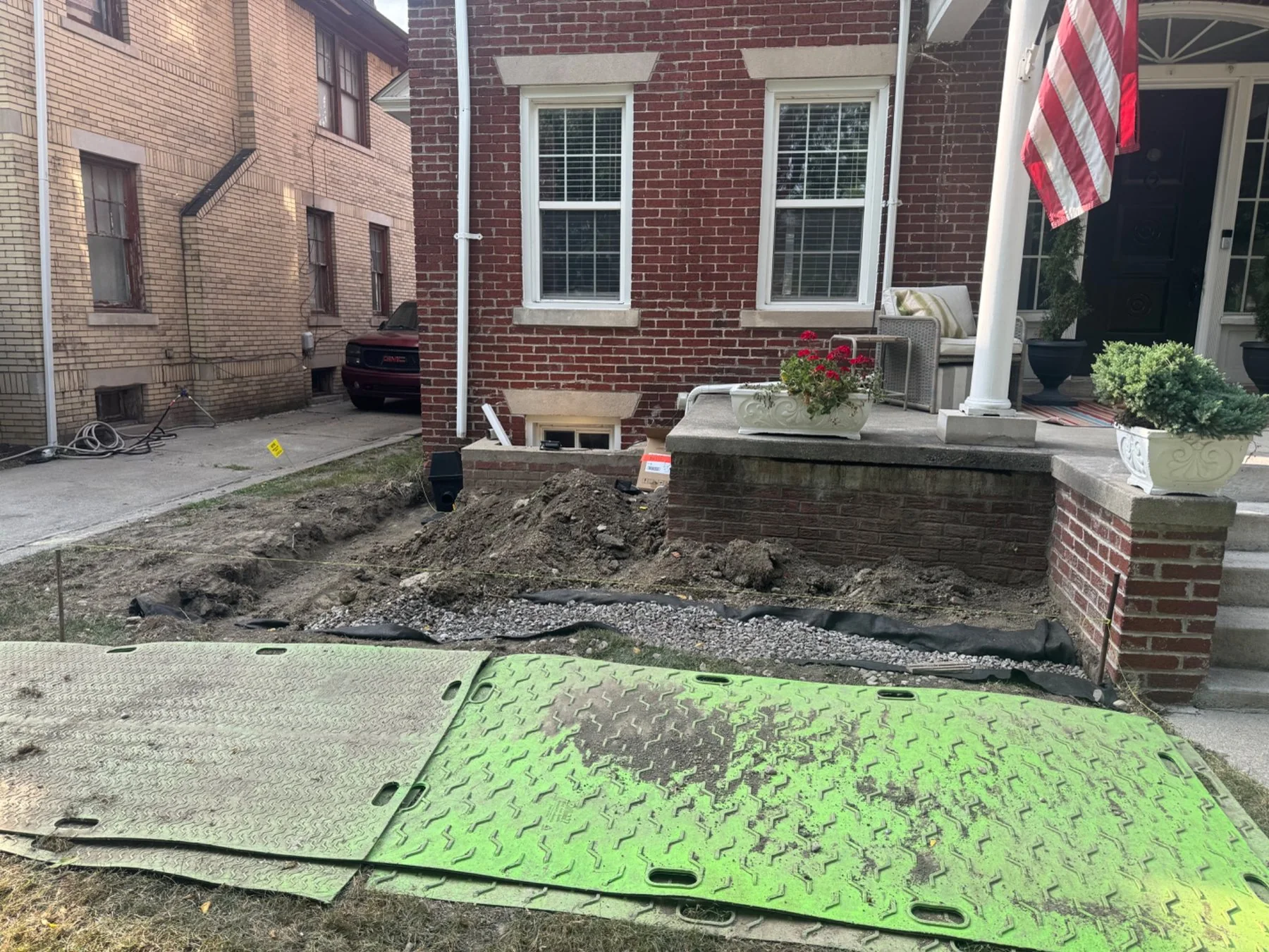 Front garden beds under construction with stone edging and gravel