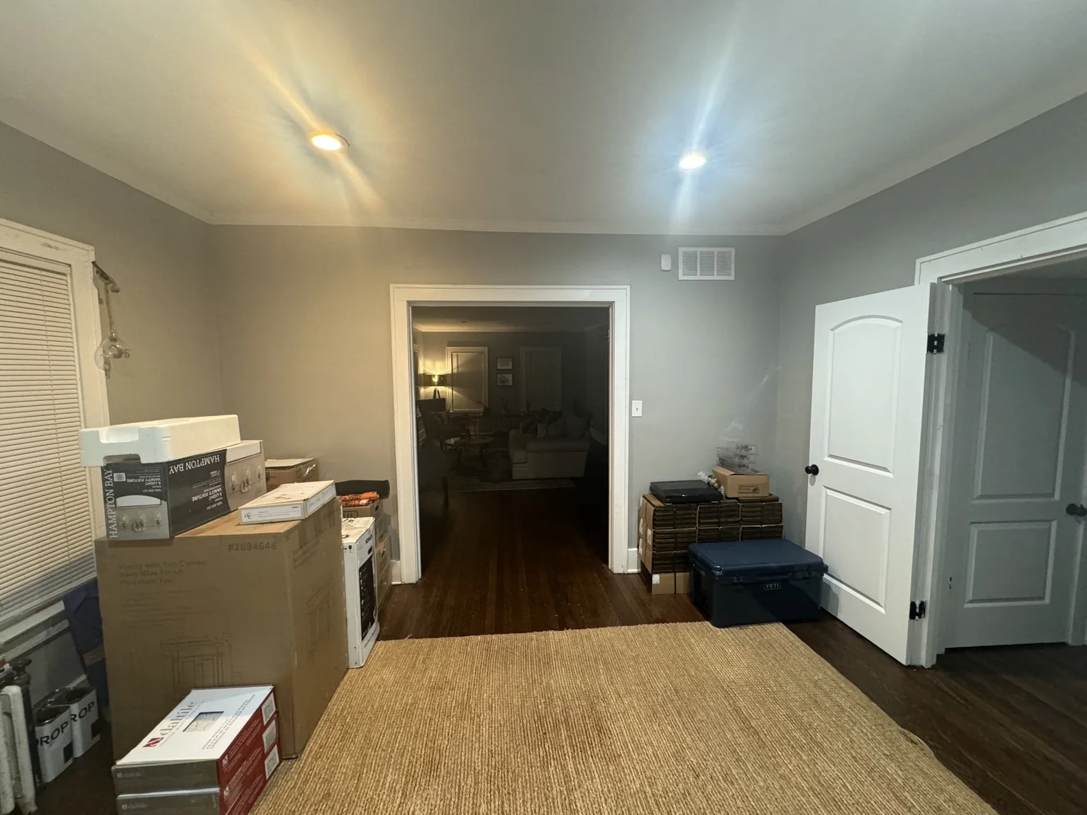 Library room before the transformation with gray walls and moving boxes