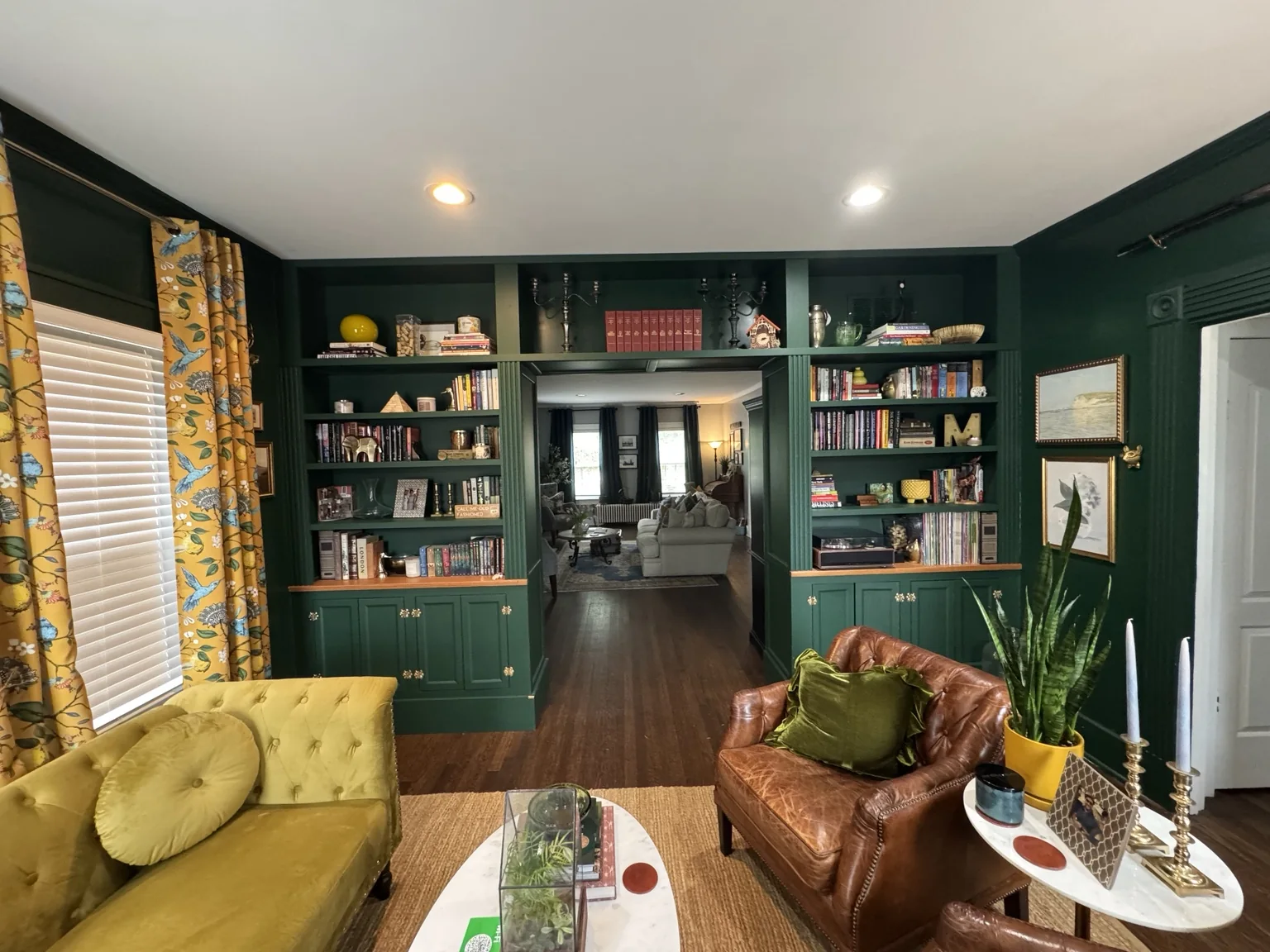 Finished library at The Meeks House with green built-ins and warm furnishings