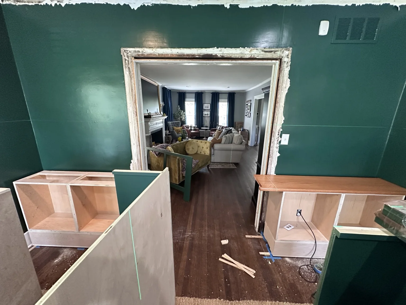 Lower cabinet bases positioned around the stripped library opening during installation