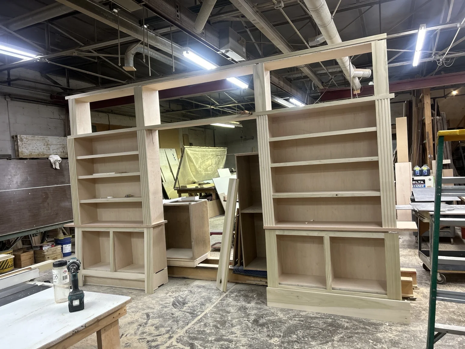 Custom library built-ins under construction in a woodworking shop