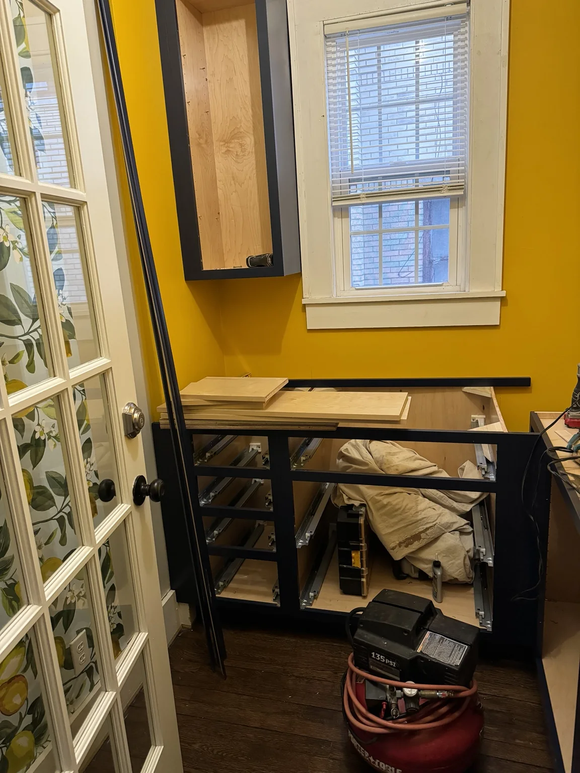Pantry cabinetry installation in progress beneath the window