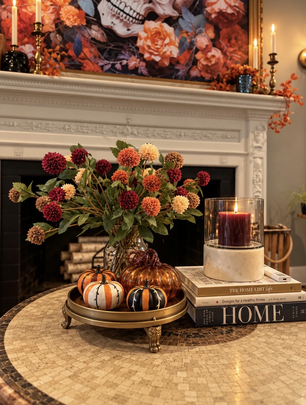 Coffee table fall arrangement with dahlias, pumpkins, and candle in front of the fireplace